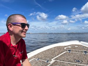 Photo of Travelers claim professional Scott C. sitting on a boat back to the mainland.