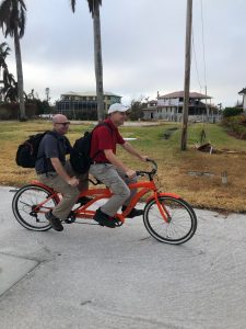 Travelers claim professionals Kevin L. and Scott C. riding on a tandem bicycle.