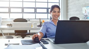 Shot of a young businesswoman using a laptop at work