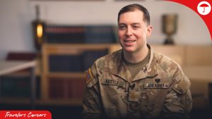 A Travelers employee who is also a member of the National Guard sits in an interview in uniform.