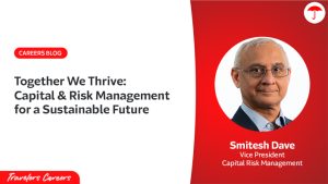 Travelers Careers blog header with split design. Left side features white background with red 'CAREERS BLOG' label and title 'Together We Thrive: Capital & Risk Management for a Sustainable Future' in dark text, with Travelers Careers logo at bottom. Right side has red background with circular professional headshot of Smitesh Dave, Vice President of Capital Risk Management, wearing glasses and dark suit. Travelers umbrella logo in top right corner.
