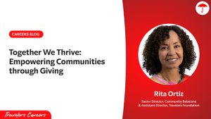 Promotional graphic for the Travelers Careers blog titled ‘Together We Thrive: Empowering Communities through Giving.’ The left side features the headline and Travelers Careers logo on a white background, and the right side shows a professional headshot of Senior Director of Community Relations and Assistant Director of the Travelers Foundation, Rita Ortiz, smiling in front of a red background with the Travelers umbrella logo.