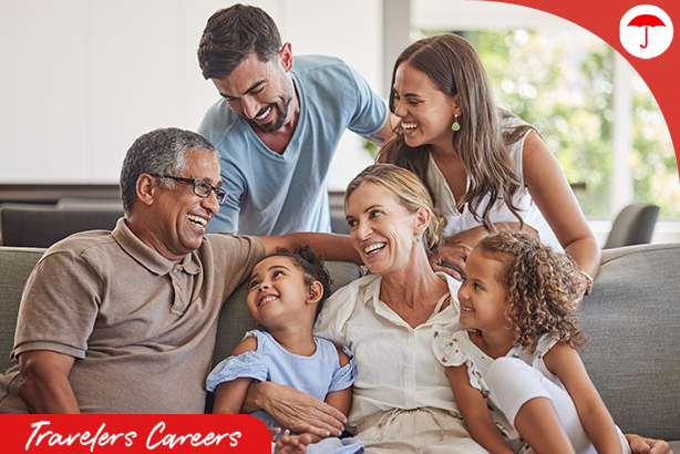 Multi-generational family smiling together on a couch.